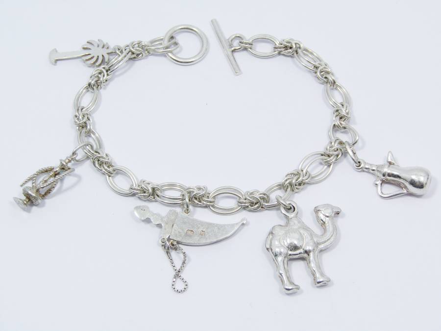 A Lovely Weighty Bracelet With Charms in Sterling Silver.