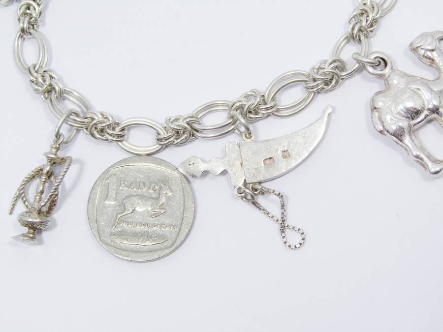 A Lovely Weighty Bracelet With Charms in Sterling Silver.