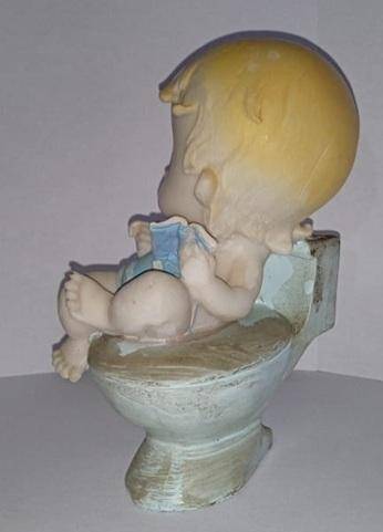 Boy on toilet figurine
