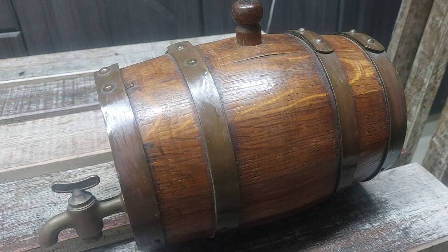 Vintage heavy solid oak wine barrel with brass tap and straps