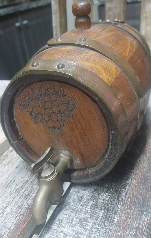 Vintage heavy solid oak wine barrel with brass tap and straps