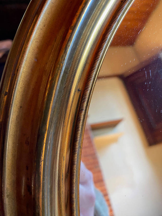 EDWARDIAN OVAL BRASS-FRAMED WALL MIRROR