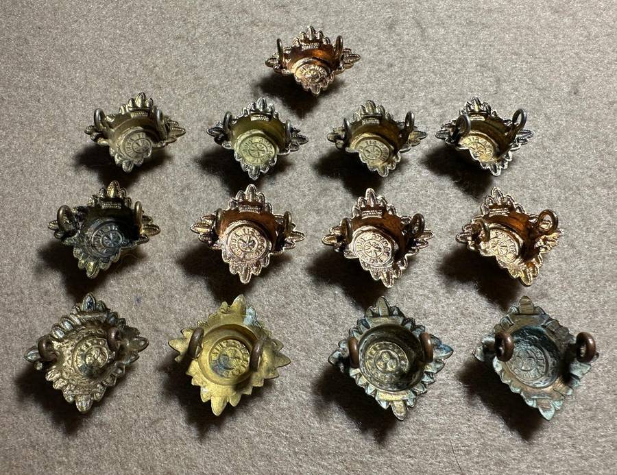RHODESIA CROWNS AND PIPS - 13 BRASS PIPS WITH RED ENAMEL - VARIED