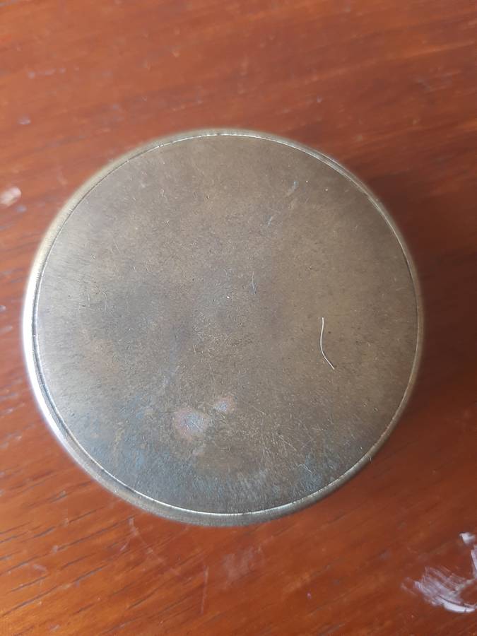 small compass in brass holder