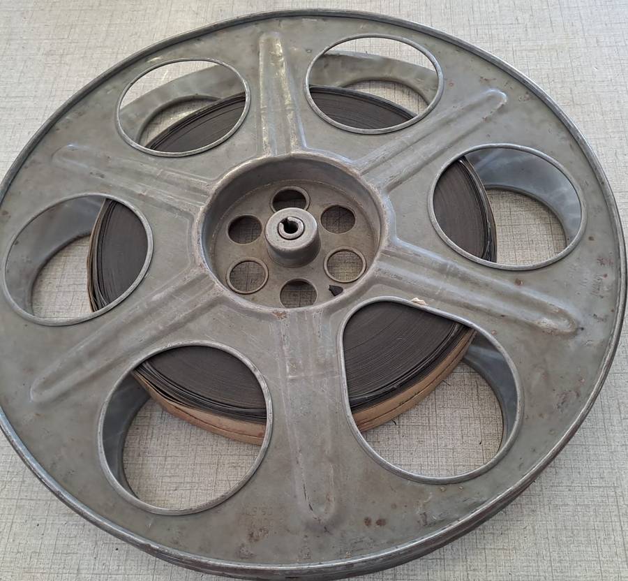Vintage film reel with African Consolidated Films tag. See description.