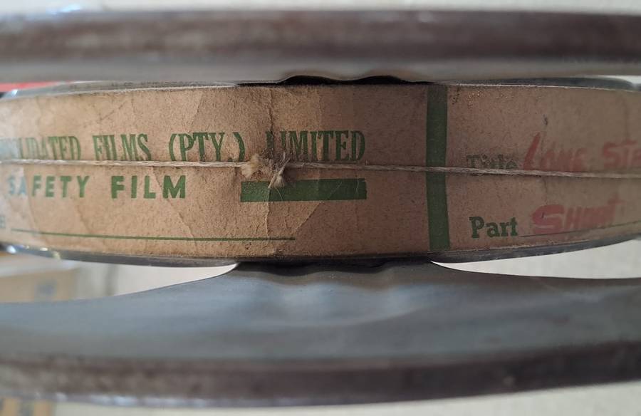 Vintage film reel with African Consolidated Films tag. See description.