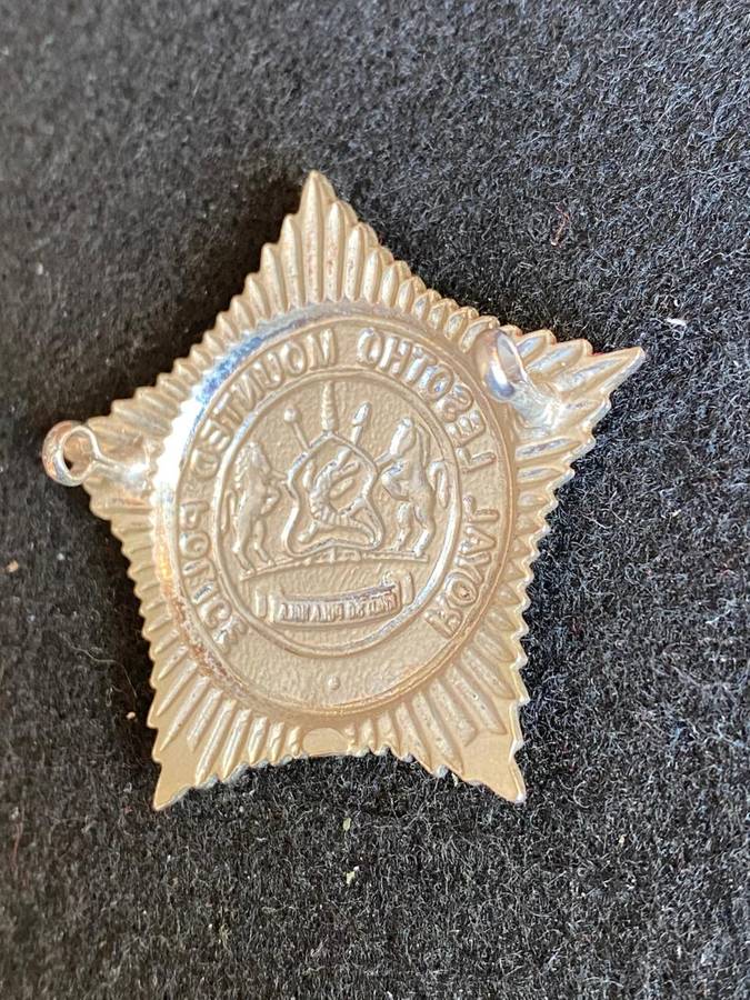 ROYAL LESOTHO MOUNTED POLICE ,WHITE METAL CAP BADGE- 2 LUGS
