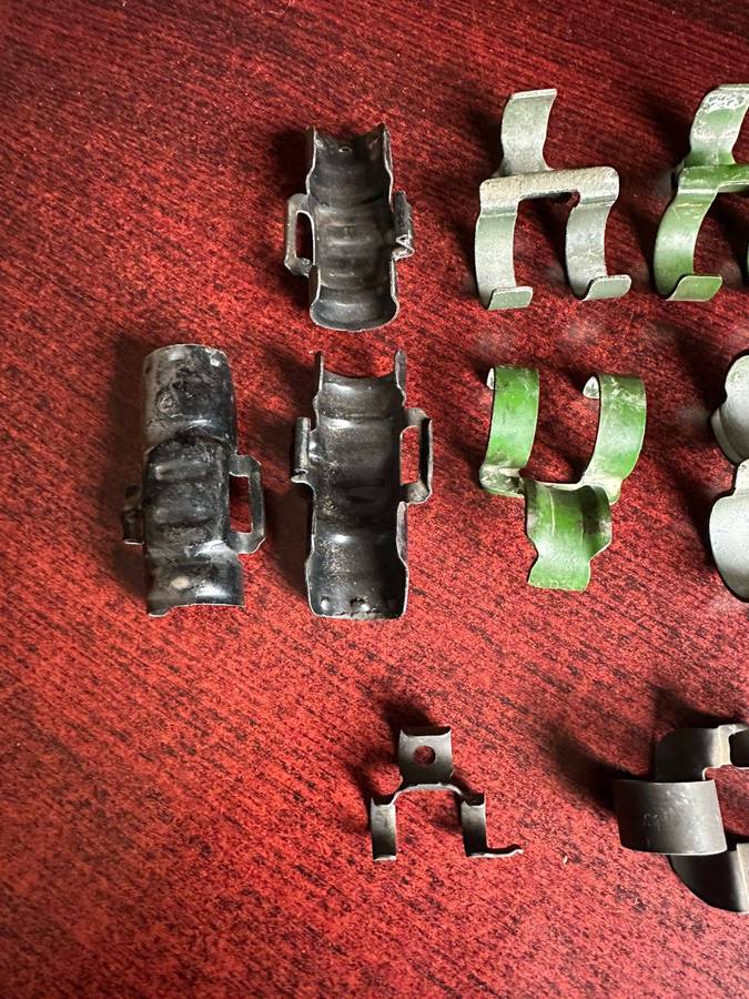Selection of machine gun belt clips. 9 In total.