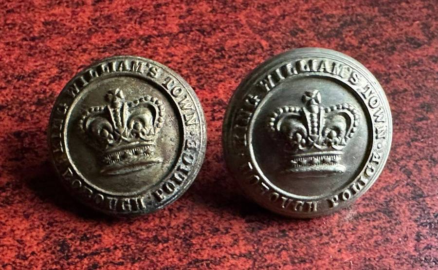 King Williams Town borough police buttons. Worn pre 1902(Queens Crown)white metal. Diameter 25 mm.