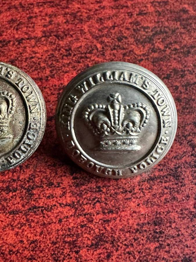 King Williams Town borough police buttons. Worn pre 1902(Queens Crown)white metal. Diameter 25 mm.
