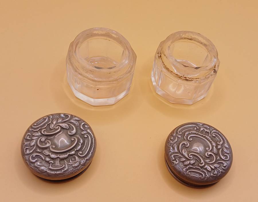 Two small marked silver and glass vanity jars lion facing left