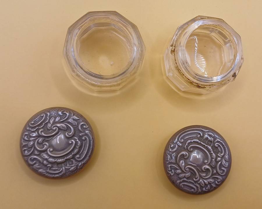 Two small marked silver and glass vanity jars lion facing left
