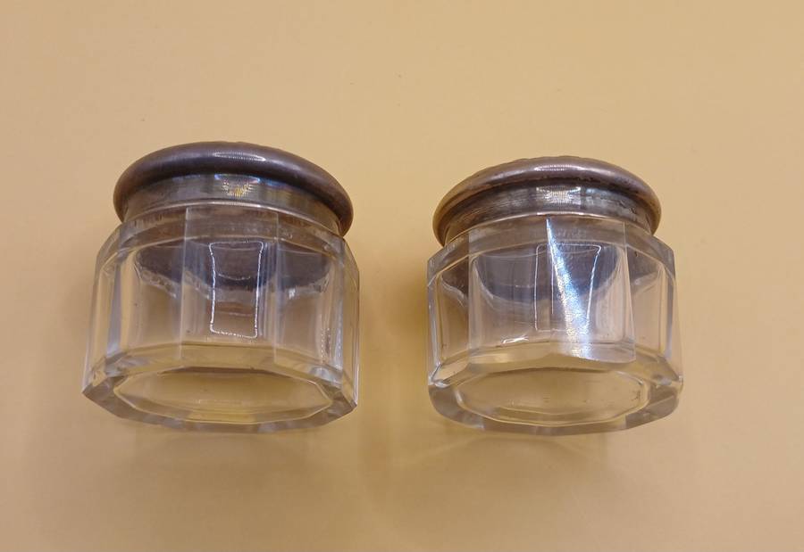 Two small marked silver and glass vanity jars lion facing left