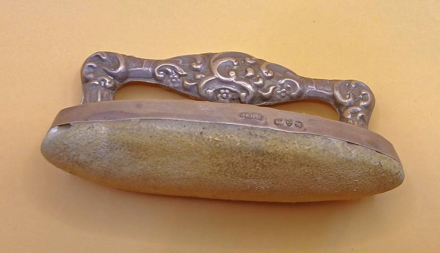 Marked silver nail buffer lion facing left