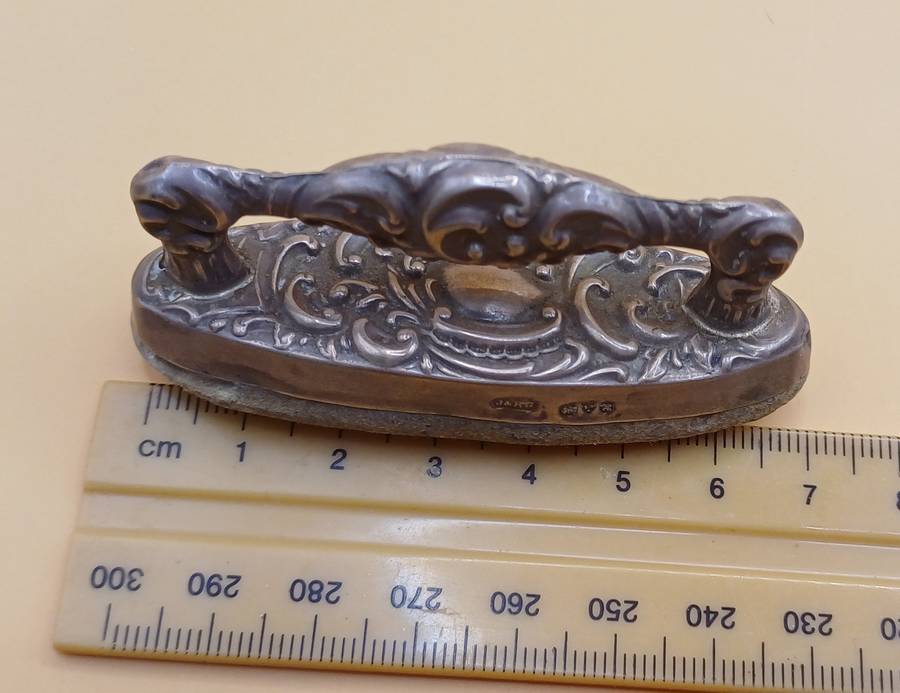 Marked silver nail buffer lion facing left