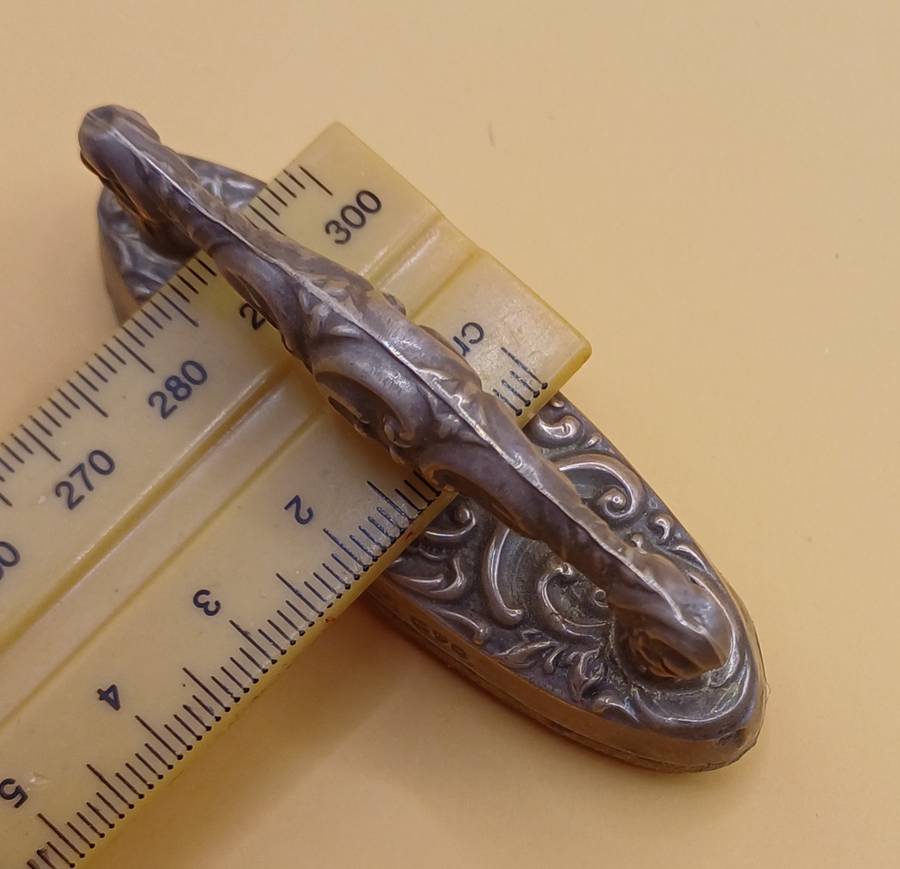 Marked silver nail buffer lion facing left