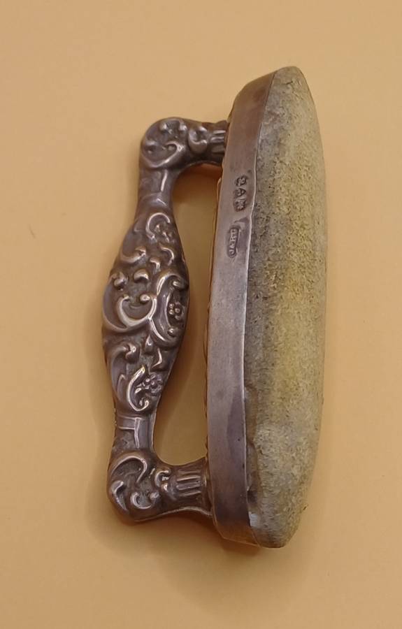 Marked silver nail buffer lion facing left