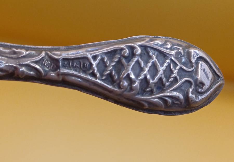 Marked silver nail file lion facing left