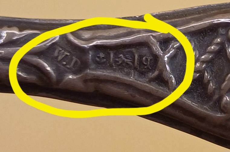 Marked silver nail file lion facing left