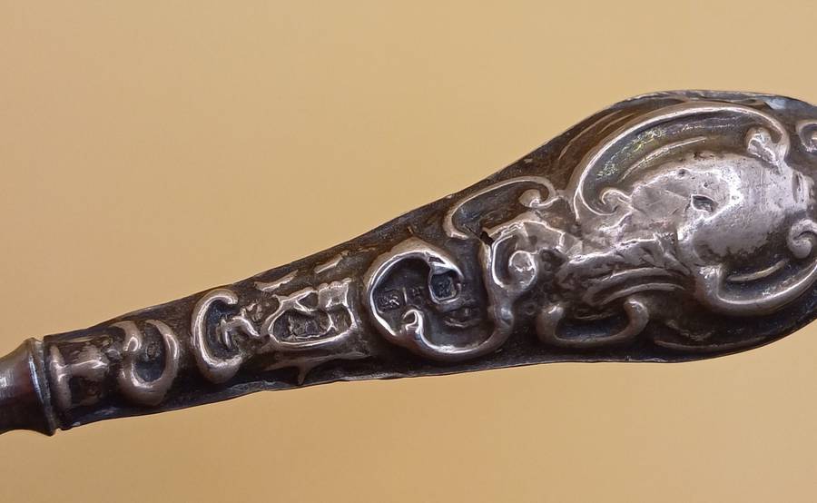 Marked silver lion facing left