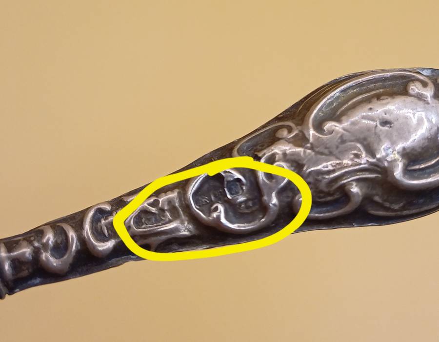 Marked silver lion facing left