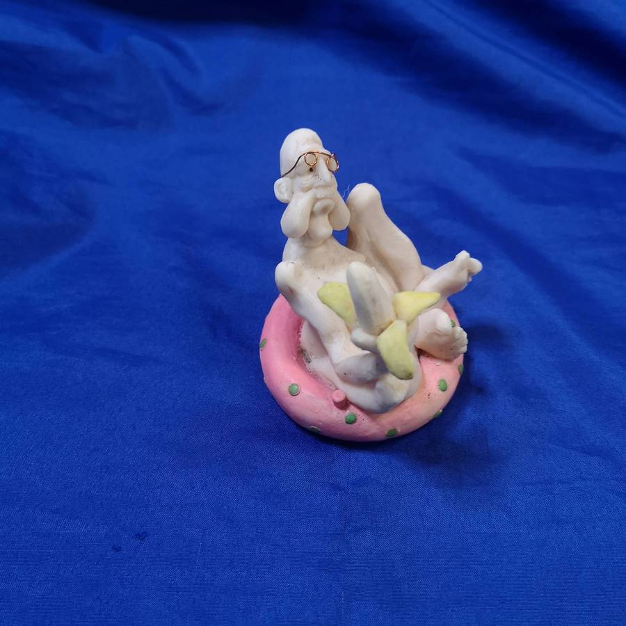 Rare Ornament. "Old Man with a Banana on a Pool Floatie"