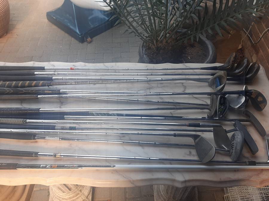 Assorted golf clubs