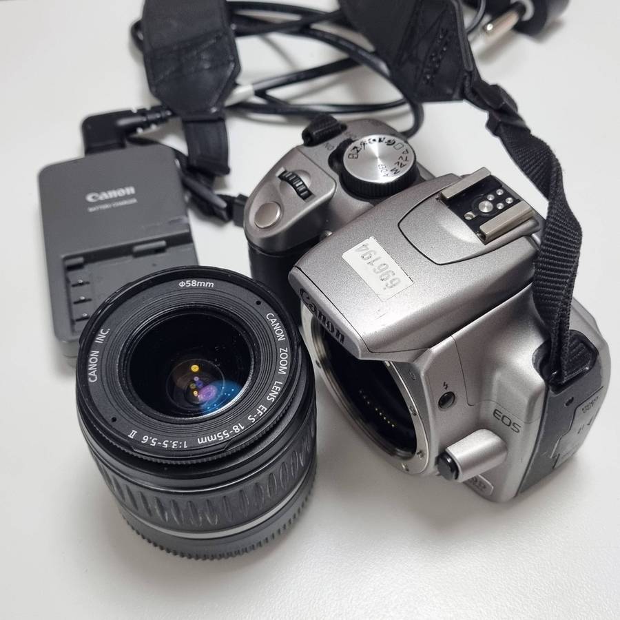 Canon Dslr Camera with original charger, battery and Canon EF-S 1855mm f/3.55.6 kit lens.
