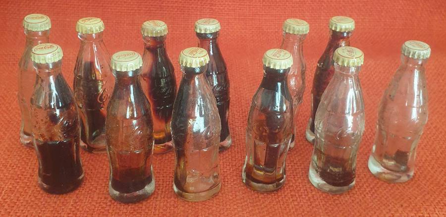 12 x Vintage miniature Coca-Cola bottles (with original caps)