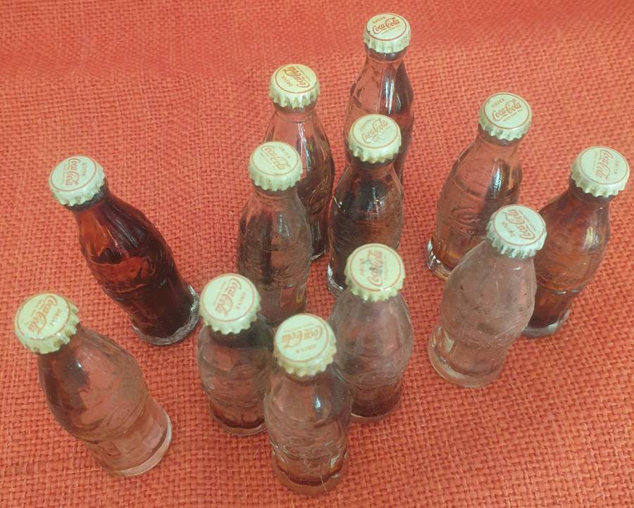12 x Vintage miniature Coca-Cola bottles (with original caps)