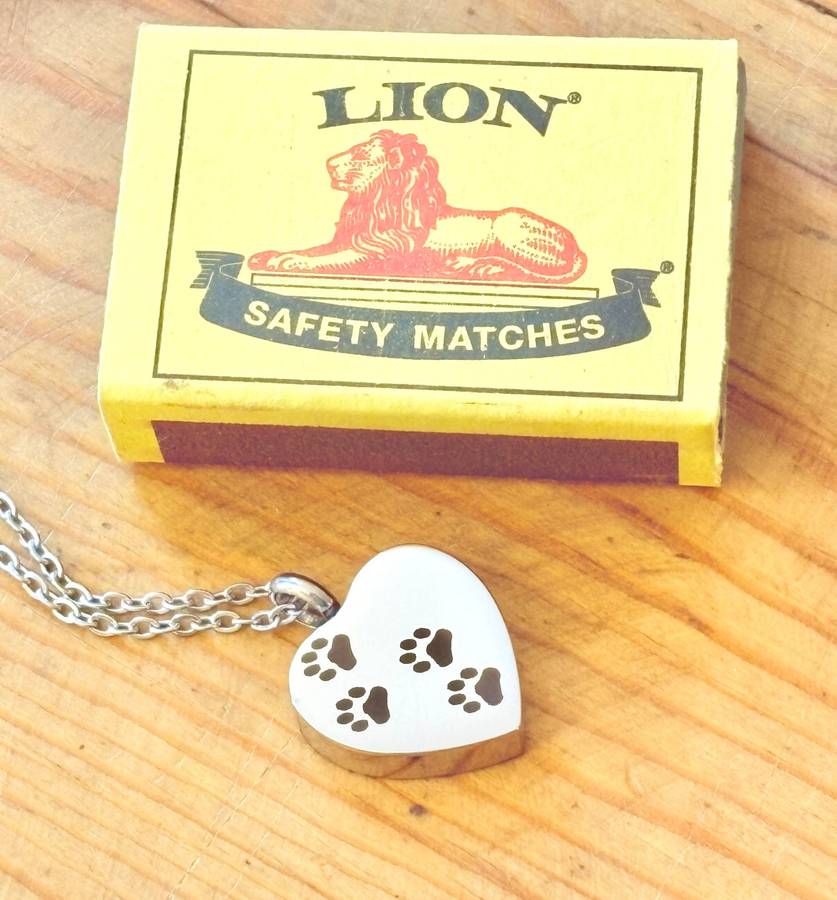 Keepsake urn pendant. Heart shaped, 4 paw prints. Stainless steel.
