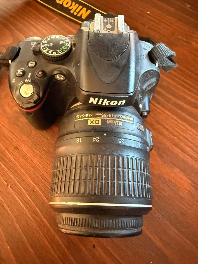 Nikon D5100 DSLR camera with 2 lenses, flash and spare batteries and charger