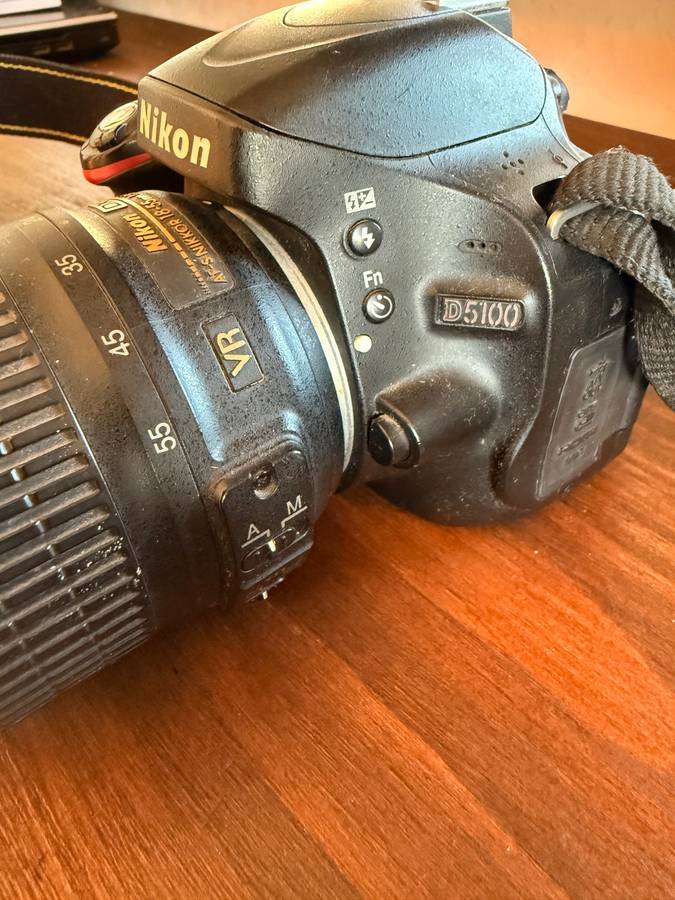 Nikon D5100 DSLR camera with 2 lenses, flash and spare batteries and charger