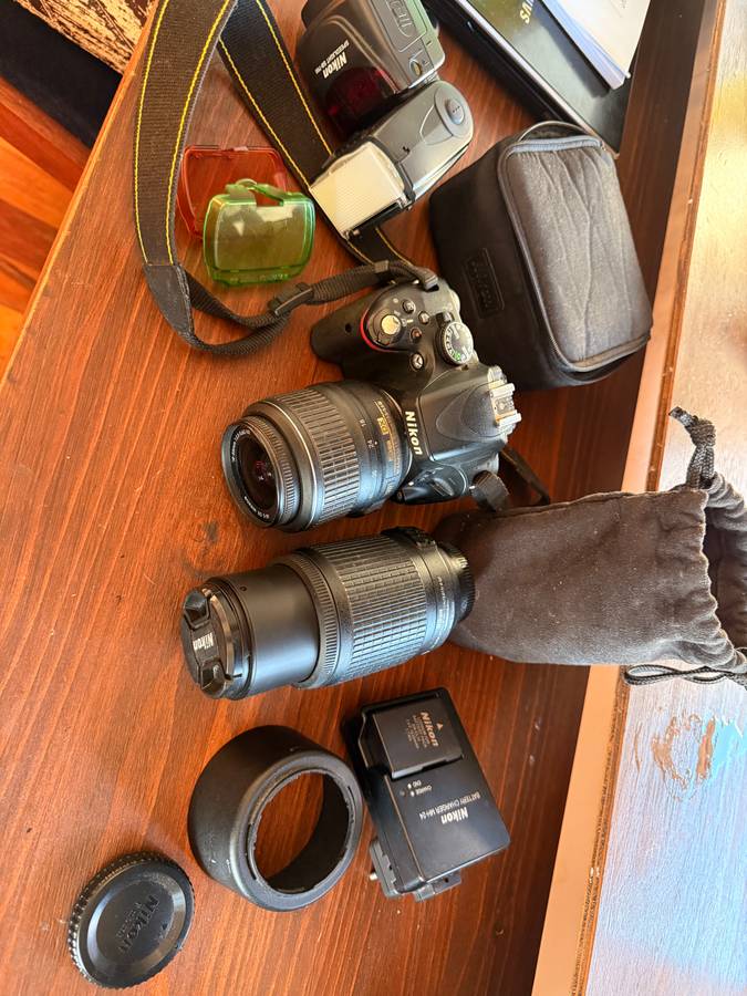 Nikon D5100 DSLR camera with 2 lenses, flash and spare batteries and charger