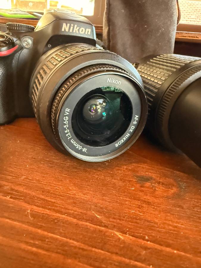 Nikon D5100 DSLR camera with 2 lenses, flash and spare batteries and charger