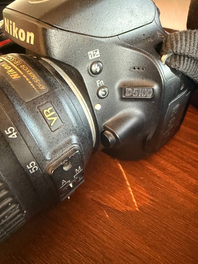 Nikon D5100 DSLR camera with 2 lenses, flash and spare batteries and charger
