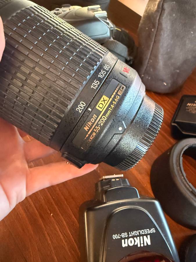 Nikon D5100 DSLR camera with 2 lenses, flash and spare batteries and charger