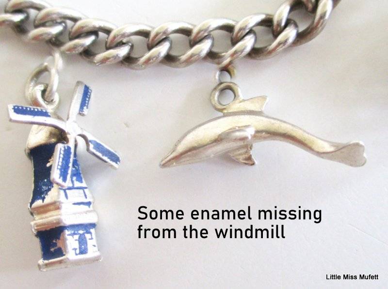 A Sterling silver charm bracelet with some interesting charms and a St. Christopher--21 Gram plus