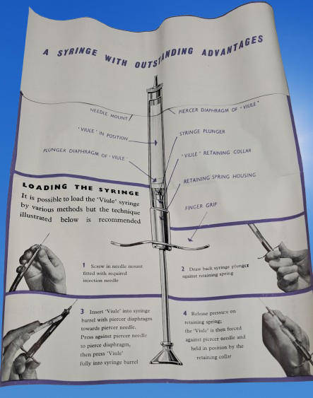 Boots viule syringe in a metal case with two glass containers with needles inside.