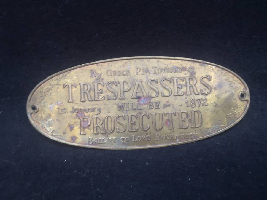 Brass sign: Trespassers will be prosecuted