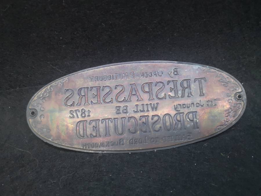 Brass sign: Trespassers will be prosecuted