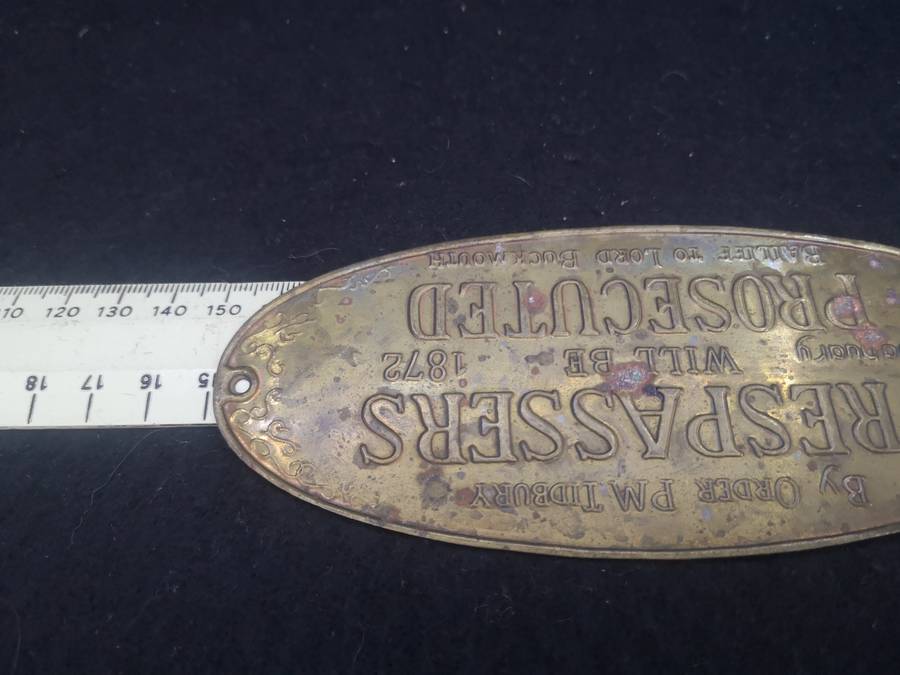 Brass sign: Trespassers will be prosecuted