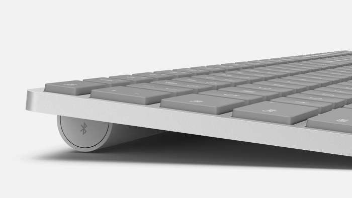 A close-up view of a Surface Keyboard showing the Bluetooth icon. 