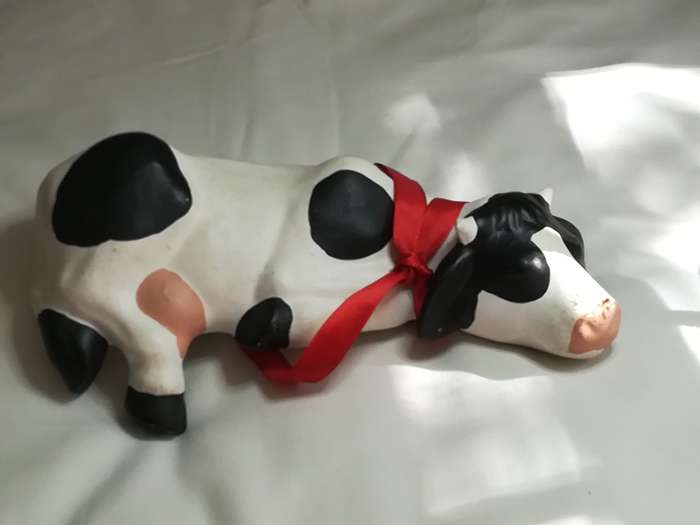 Black & White Ceramic Cow with Red Ribbon Around The Neck