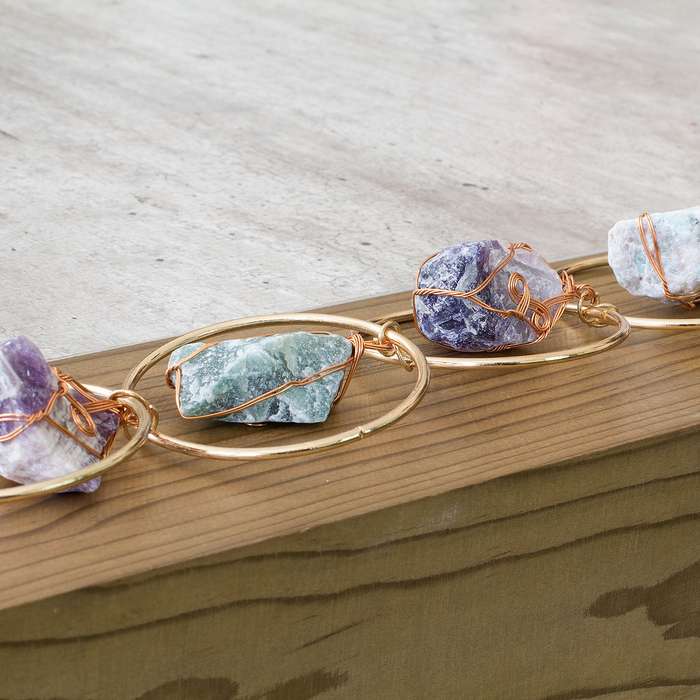 Rough natural stone, wire wrapped, iron ring wall art