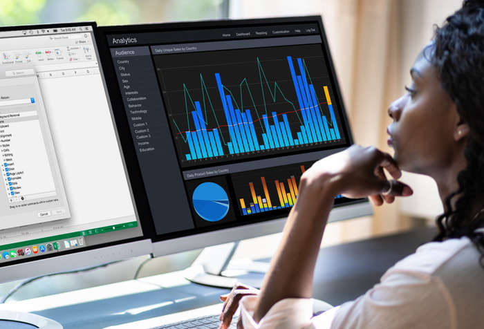 Woman Working Behind Two 4K Displays Connected to DisplayLink Dual HDMI Adapter for M1 Macs