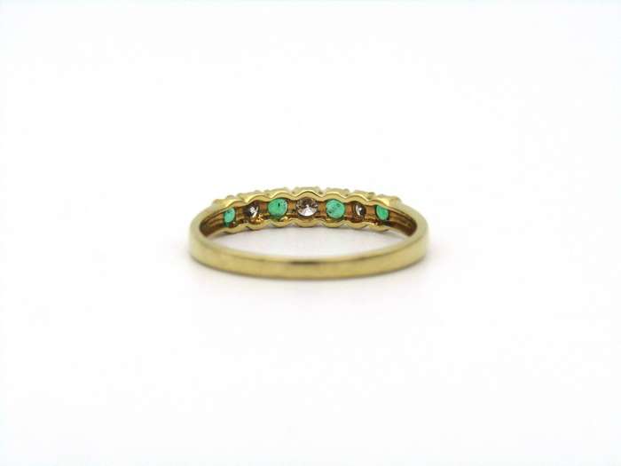 18K gold emerald and diamond ring.