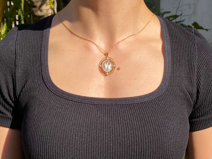 9K gold conch shell cameo and cultured akoya pearl pendant.