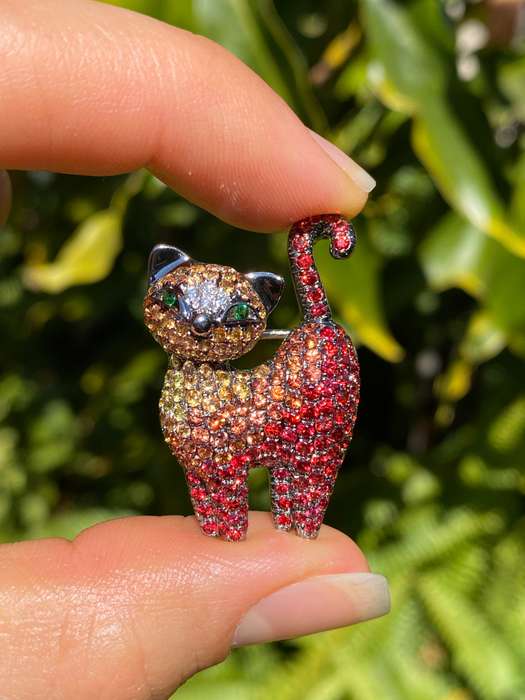 18K gold fancy sapphire, tsavorite garnet and diamond cat pendant/brooch.