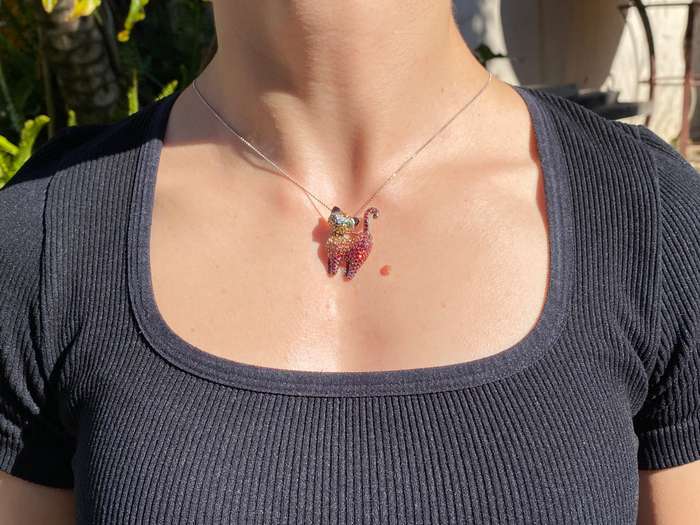 18K gold fancy sapphire, tsavorite garnet and diamond cat pendant/brooch.